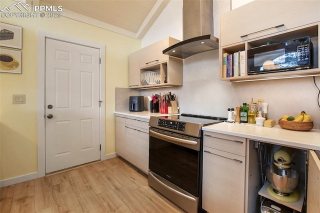 500 W Kellys Rd, Woodland Park, CO 80863 - kitchen with stainless steel electric range, wall chimney range hood, black microwave, light wood-style flooring, and light countertops
