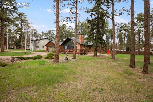 500 W Kellys Rd, Woodland Park, CO 80863 - view of green lawn with a garage and driveway