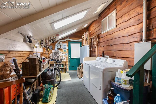 500 W Kellys Rd, Woodland Park, CO 80863 - laundry room with washer and dryer, a skylight, wood walls, and carpet flooring