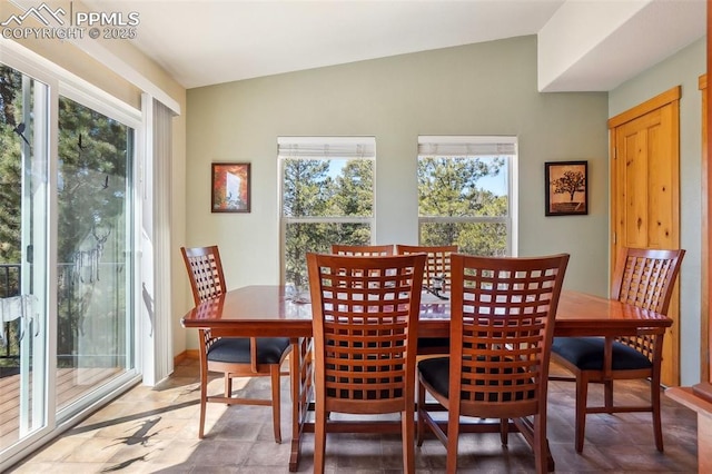 dining area featuring vaulted ceiling