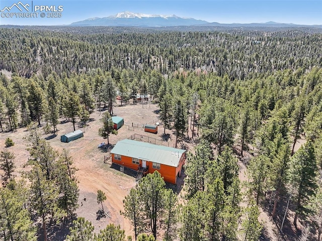 aerial view featuring a mountain view and a wooded view