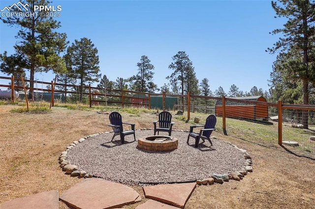 view of yard with a fenced backyard and an outdoor fire pit
