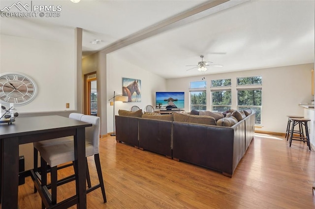 living area with ceiling fan and light wood-style flooring
