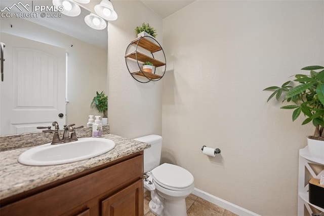 half bathroom with toilet, baseboards, tile patterned floors, and vanity