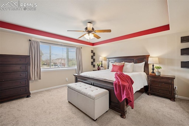 carpeted bedroom featuring baseboards and ceiling fan