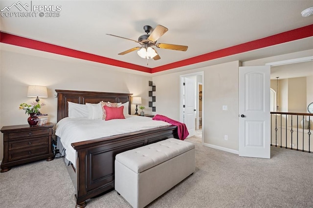 bedroom featuring baseboards, light carpet, and a ceiling fan