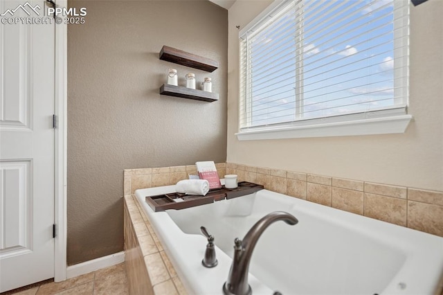 full bathroom featuring a garden tub, baseboards, plenty of natural light, and tile patterned floors