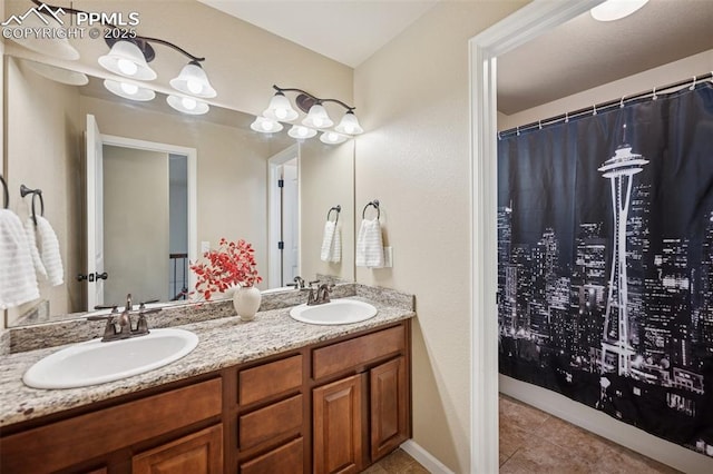 bathroom featuring a sink, tile patterned floors, and double vanity