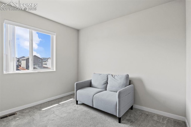 living area featuring baseboards, carpet, and visible vents