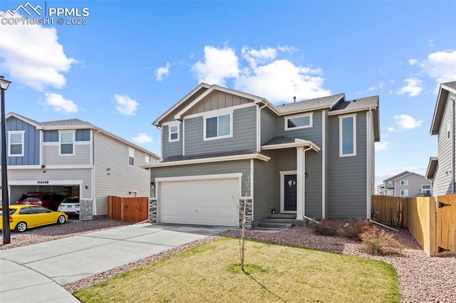 view of front of house featuring fence, stone siding, board and batten siding, concrete driveway, and an attached garage