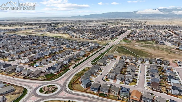 drone / aerial view featuring a residential view and a mountain view