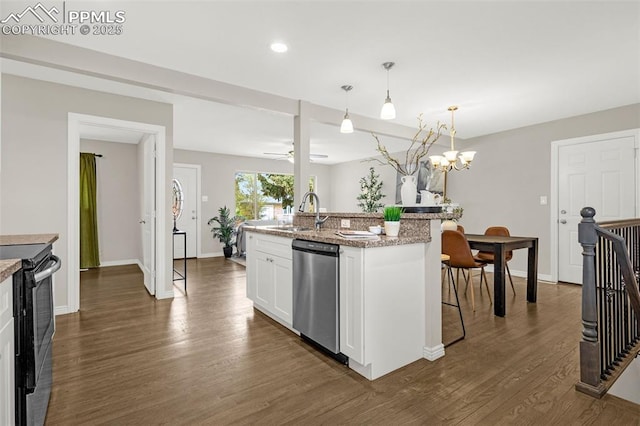 kitchen featuring stainless steel dishwasher, electric range, dark wood-type flooring, white cabinetry, and a sink