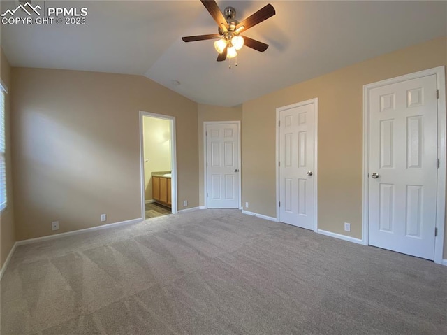 2748 Scotchbroom Pt, Colorado Springs, CO 80910 - unfurnished bedroom with lofted ceiling, carpet, ensuite bathroom, and baseboards