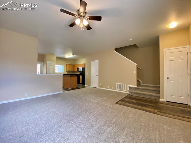 2748 Scotchbroom Pt, Colorado Springs, CO 80910 - unfurnished living room with baseboards, visible vents, ceiling fan, and carpet