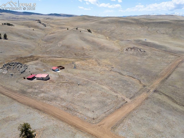 bird's eye view featuring a rural view, a mountain view, and view of desert