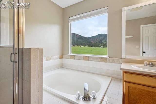 133 Wheat Ridge St, Palmer Lake, CO 80133 - full bath featuring vanity, a bath, a mountain view, and a stall shower