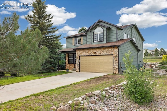 133 Wheat Ridge St, Palmer Lake, CO 80133 - view of front of property featuring stone siding, concrete driveway, and an attached garage