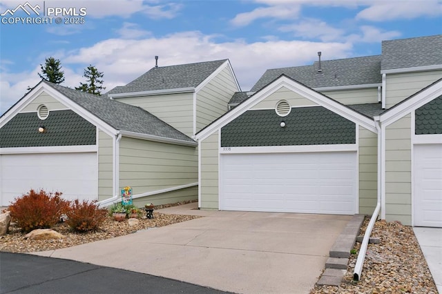 multi unit property with driveway, roof with shingles, and a garage