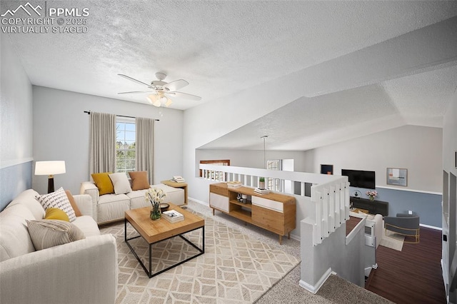 living room with a ceiling fan, a textured ceiling, vaulted ceiling, and baseboards