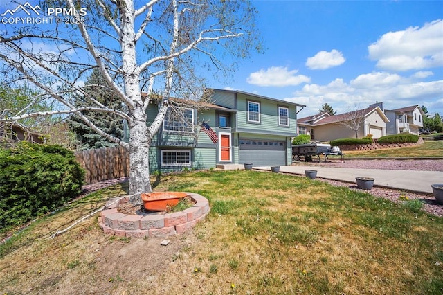 view of front facade with driveway, a front lawn, and a garage