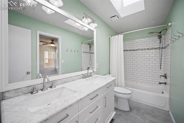 full bathroom featuring visible vents, a sink, shower / bath combo with shower curtain, and a skylight