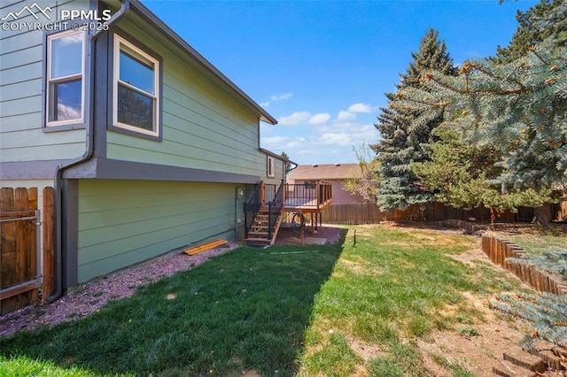 view of yard featuring stairway, a wooden deck, and a fenced backyard