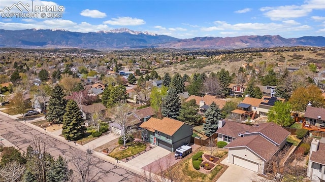 drone / aerial view featuring a residential view and a mountain view