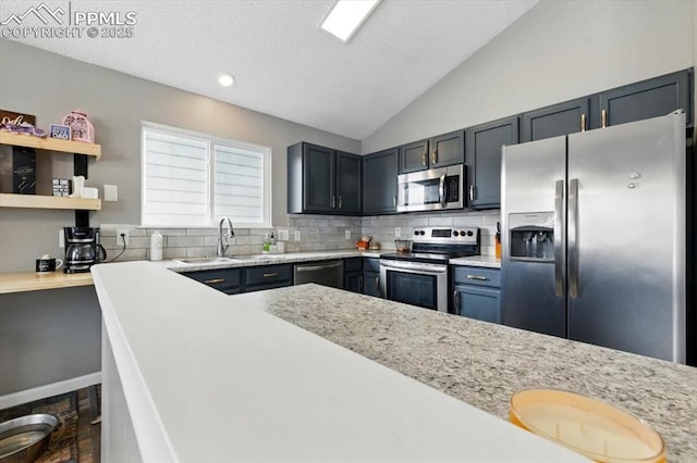 2032 Woodsong Way, Fountain, CO 80817 - kitchen with appliances with stainless steel finishes, a sink, decorative backsplash, a textured ceiling, and lofted ceiling