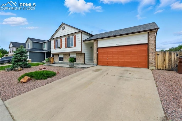 2032 Woodsong Way, Fountain, CO 80817 - view of front of property featuring brick siding, a garage, and driveway