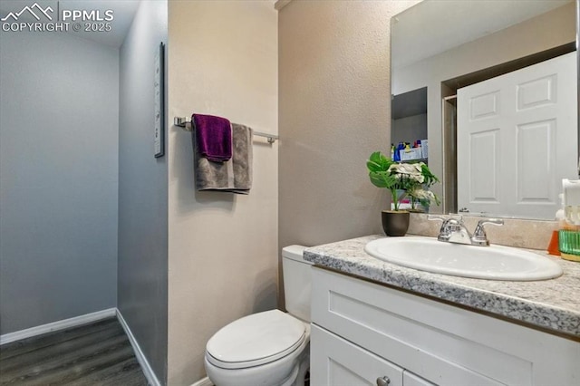 2032 Woodsong Way, Fountain, CO 80817 - bathroom featuring vanity, toilet, and wood finished floors