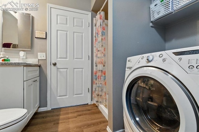 2032 Woodsong Way, Fountain, CO 80817 - laundry area with washer / dryer, wood finished floors, and baseboards