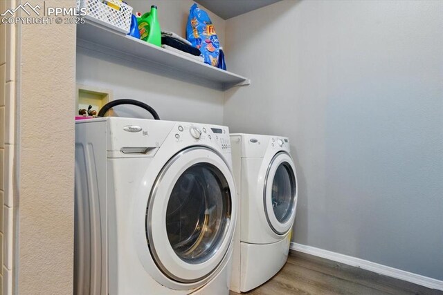2032 Woodsong Way, Fountain, CO 80817 - washroom with washing machine and dryer, wood finished floors, and baseboards