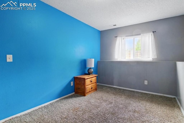 2032 Woodsong Way, Fountain, CO 80817 - unfurnished bedroom with a textured ceiling, carpet, and baseboards
