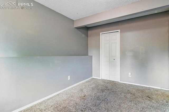 2032 Woodsong Way, Fountain, CO 80817 - spare room with carpet, baseboards, and a textured ceiling