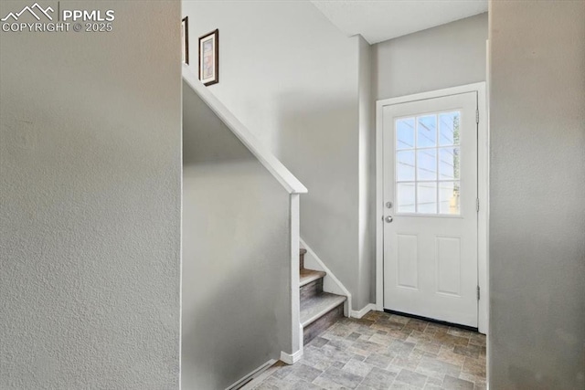 2032 Woodsong Way, Fountain, CO 80817 - entrance foyer featuring stone finish flooring, stairs, and baseboards