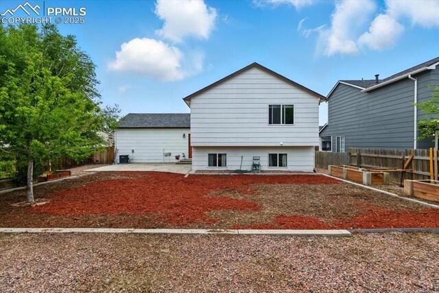 2032 Woodsong Way, Fountain, CO 80817 - rear view of house with a patio area and a garden