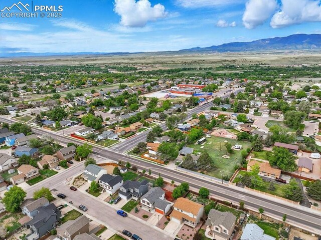 2032 Woodsong Way, Fountain, CO 80817 - aerial overview of property's location with mountains and nearby suburban area