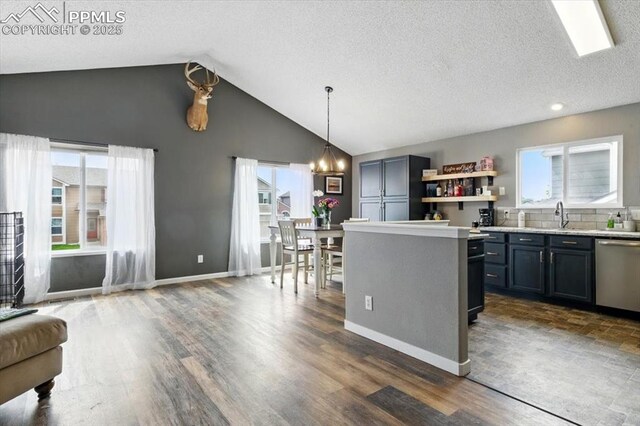 2032 Woodsong Way, Fountain, CO 80817 - kitchen with stainless steel dishwasher, a chandelier, light countertops, dark wood-style floors, and a sink
