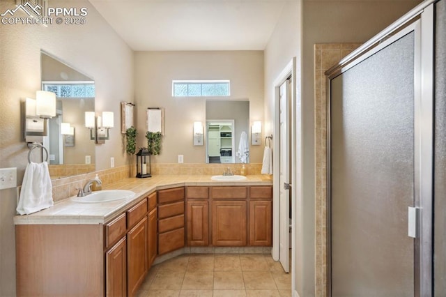 8492 Artesian Springs Pt, Colorado Springs, CO 80920 - bathroom with a stall shower, tile patterned floors, and double vanity