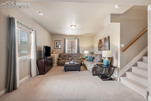 8492 Artesian Springs Pt, Colorado Springs, CO 80920 - living area featuring light carpet, baseboards, and stairway