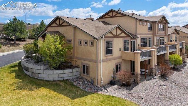8492 Artesian Springs Pt, Colorado Springs, CO 80920 - back of house featuring stucco siding and a yard