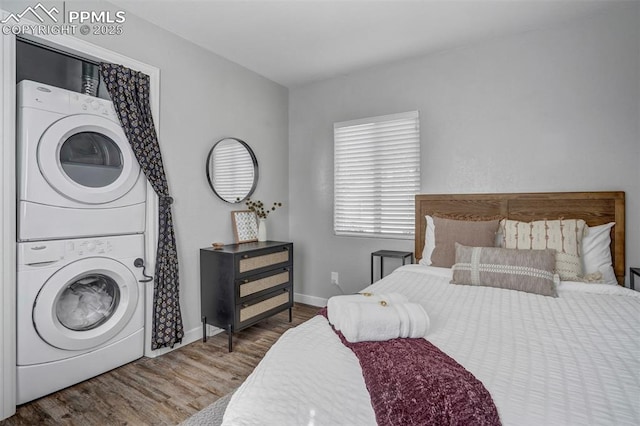 720 S Prospect St, Colorado Springs, CO 80903 - bedroom with baseboards, stacked washer / dryer, and wood finished floors