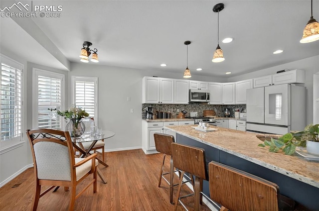 9025 Rochester Dr, Colorado Springs, CO 80920 - kitchen featuring stainless steel appliances, baseboards, plenty of natural light, and recessed lighting