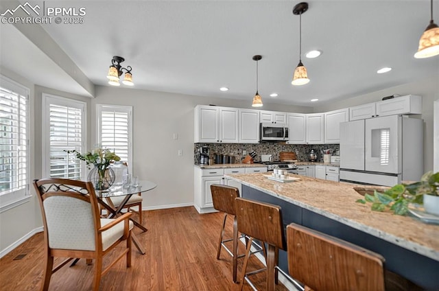 9025 Rochester Dr, Colorado Springs, CO 80920 - kitchen featuring stainless steel appliances, healthy amount of natural light, baseboards, and recessed lighting
