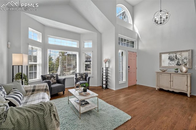 9025 Rochester Dr, Colorado Springs, CO 80920 - living area with high vaulted ceiling, wood finished floors, a chandelier, and baseboards