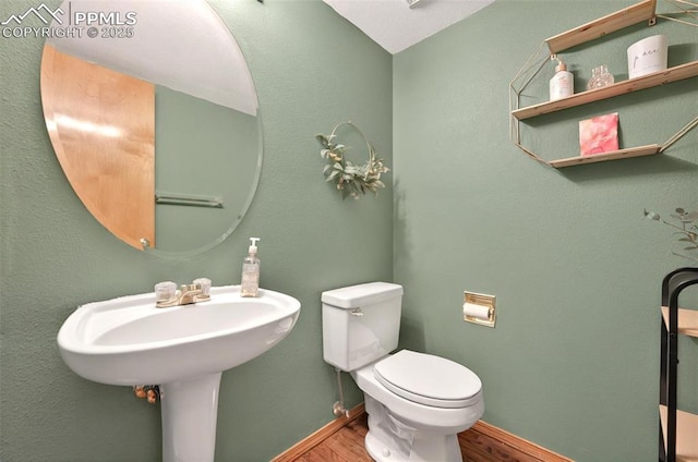9025 Rochester Dr, Colorado Springs, CO 80920 - bathroom with wood finished floors, toilet, and baseboards