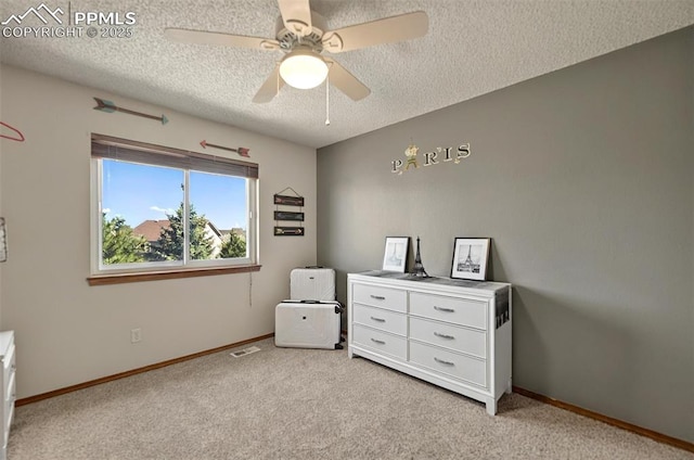 9025 Rochester Dr, Colorado Springs, CO 80920 - bedroom featuring a textured ceiling, light colored carpet, baseboards, and a ceiling fan