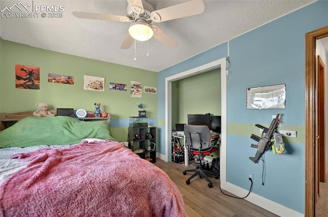 9025 Rochester Dr, Colorado Springs, CO 80920 - bedroom with wood finished floors, an office area, ceiling fan, a textured ceiling, and baseboards