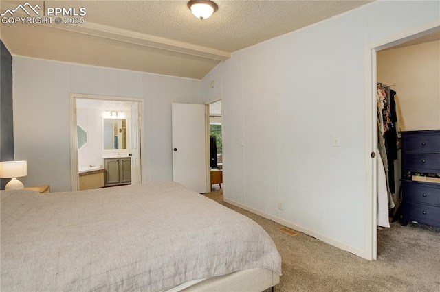 455 Clio Ave, Palmer Lake, CO 80133 - carpeted bedroom featuring a walk in closet, connected bathroom, a closet, and vaulted ceiling