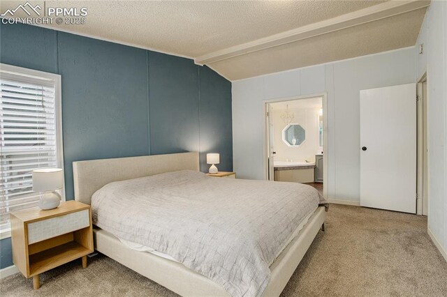 455 Clio Ave, Palmer Lake, CO 80133 - carpeted bedroom with ensuite bathroom and a textured ceiling